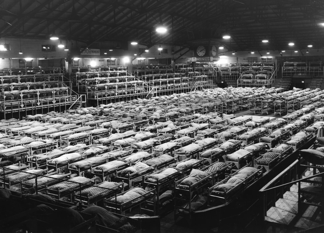 Inside the Forum building containing rows of beds