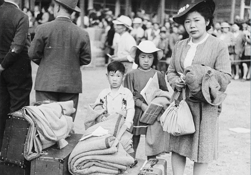 Woman and children standing with luggage